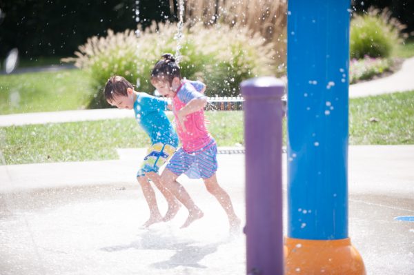 Kids having a blast at the Splash Pad in Greenwood, bringing cool fun to a hot summer day.